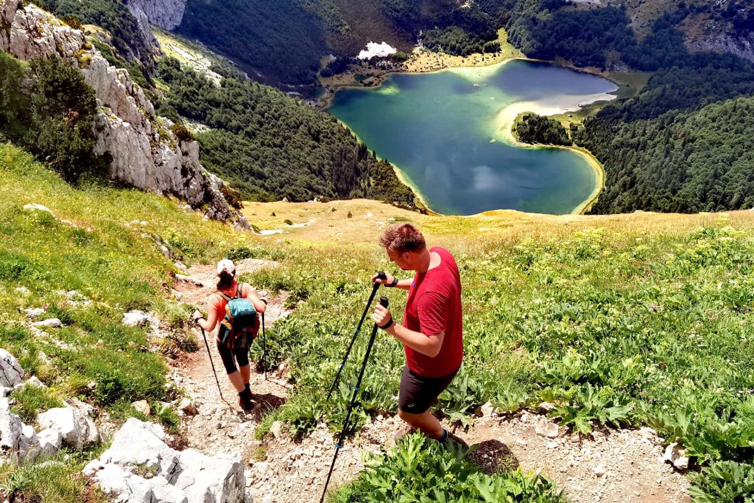 hikers above Trnovacko Lake viewpoint Sutjeska National Park